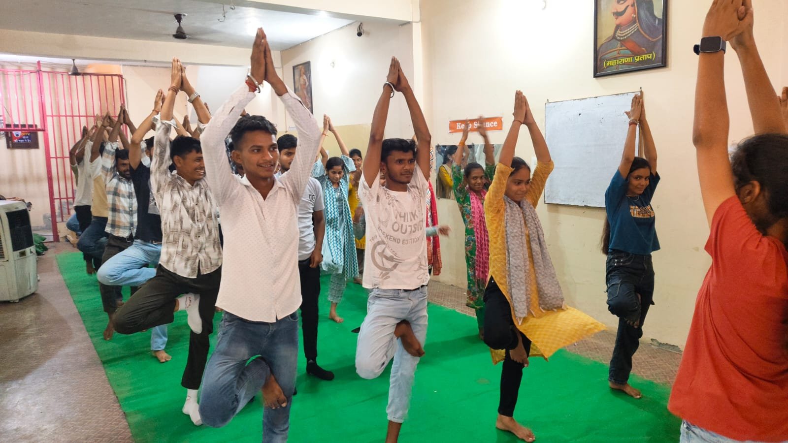 Students practising yoga tree pose during wellness session